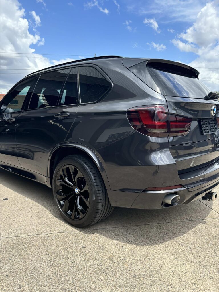Applying ceramic paint protection to BMW X5 SUV in Gold Coast